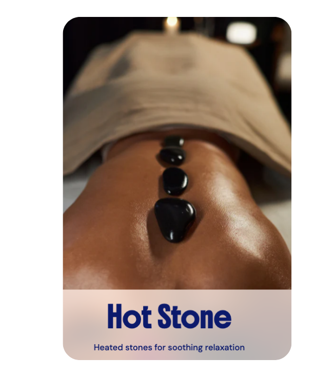 Therapeutic heated stones placed on a client's back to provide deep muscle relaxation during a Hot Stone Massage at River Oaks Thai Massage in Houston.